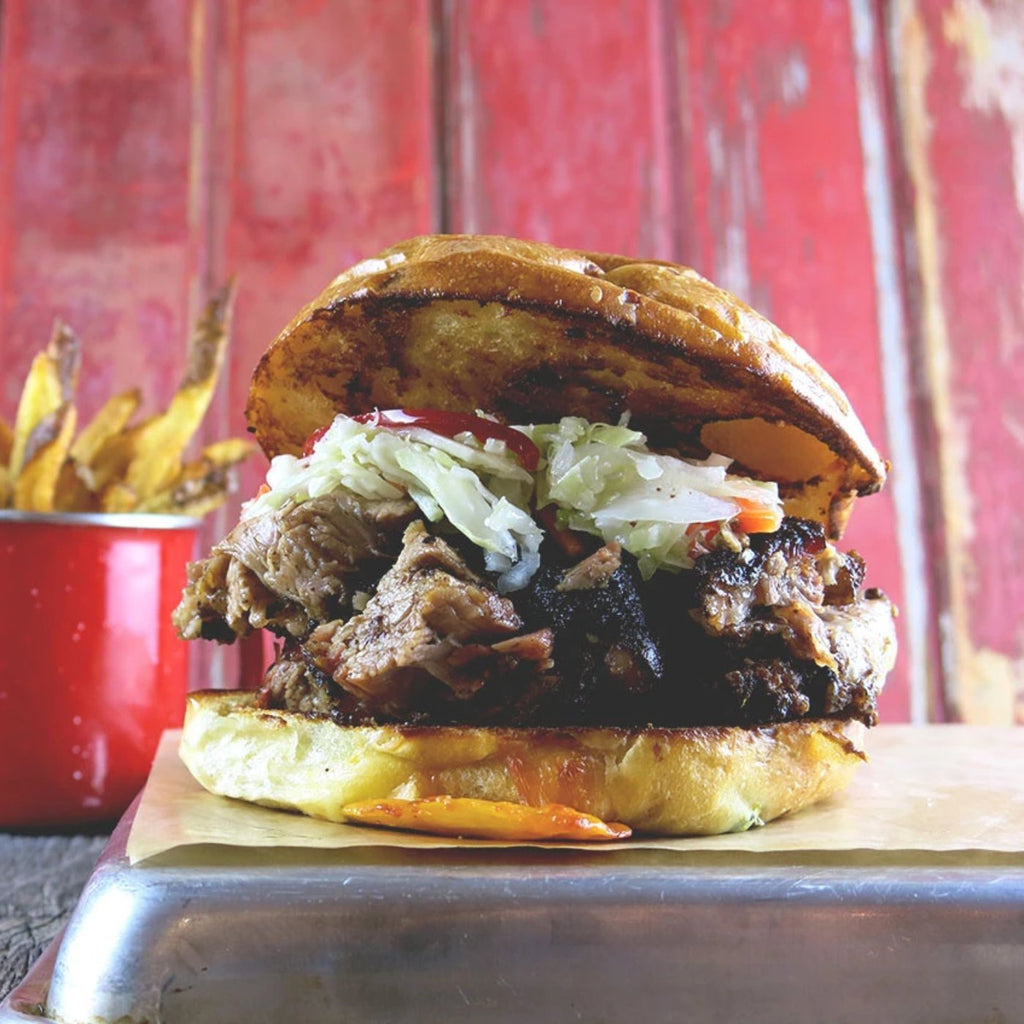 Signature Brisket Sandwich, Marinated Slaw Topper + 1 Side